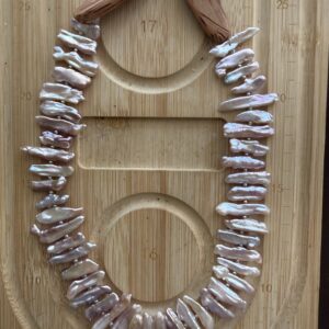 Handcrafted chicken wing wood and baroque pearl necklace featuring unique pearl teeth shapes. A nature-inspired luxury jewelry piece symbolizing beauty and harmony.