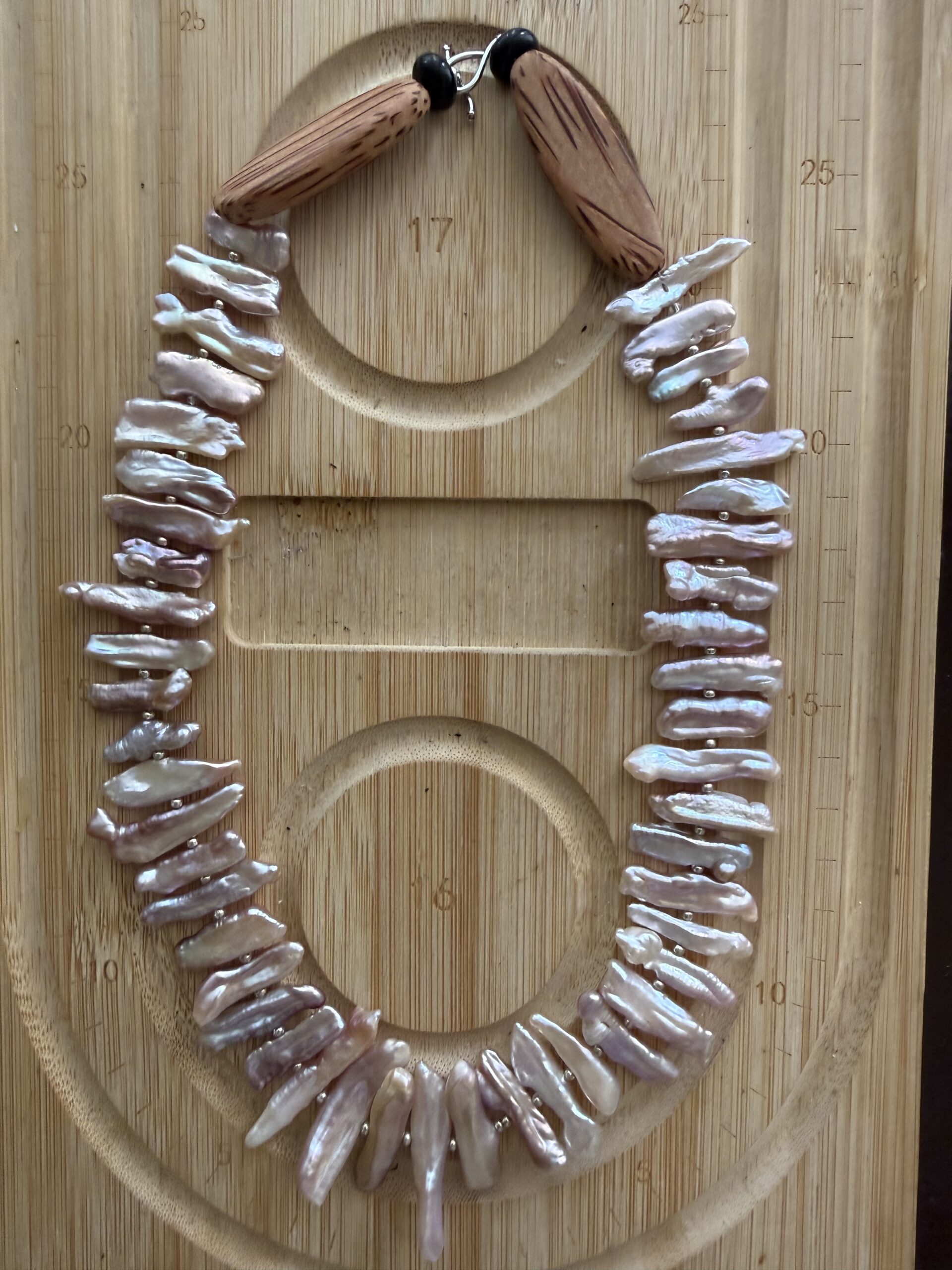 Handcrafted chicken wing wood and baroque pearl necklace featuring unique pearl teeth shapes. A nature-inspired luxury jewelry piece symbolizing beauty and harmony.