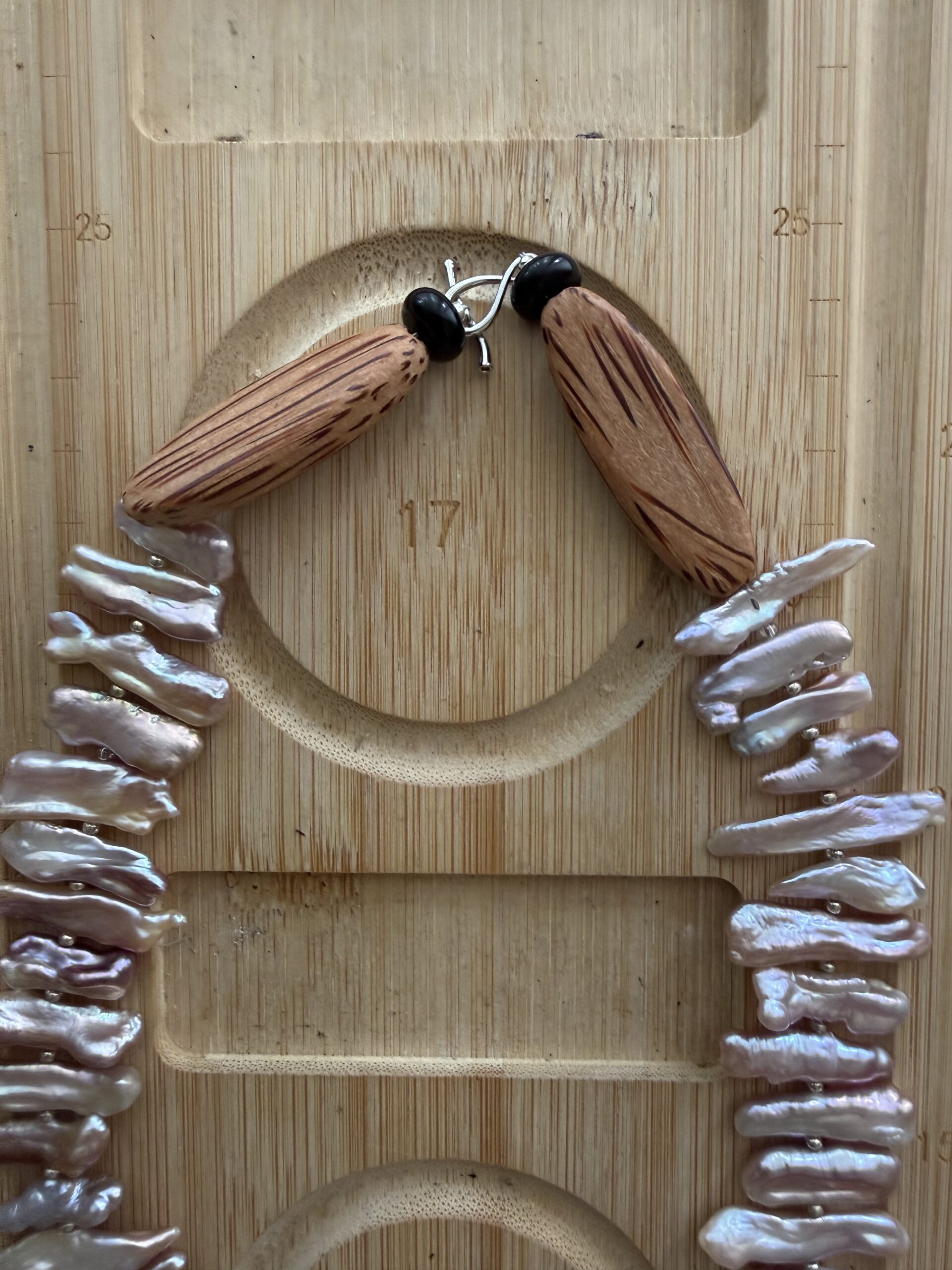 Handcrafted chicken wing wood and baroque pearl necklace featuring unique pearl teeth shapes. A nature-inspired luxury jewelry piece symbolizing beauty and harmony.